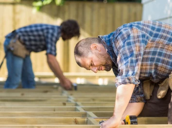 A carpenter fixing the floor.