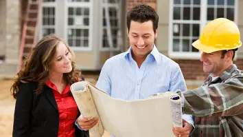 A house owner looking at the plan with the agent and the contractor.