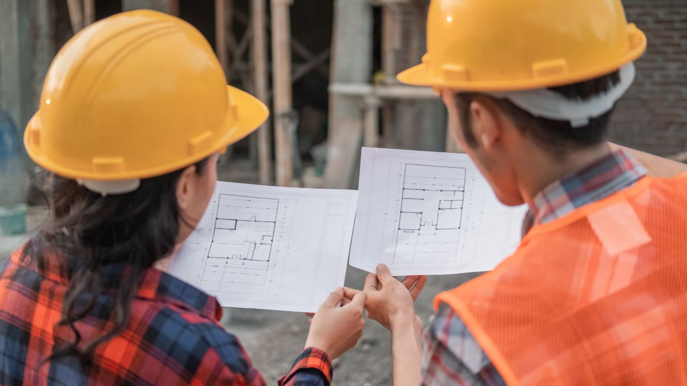 Two contractors looking at the plan