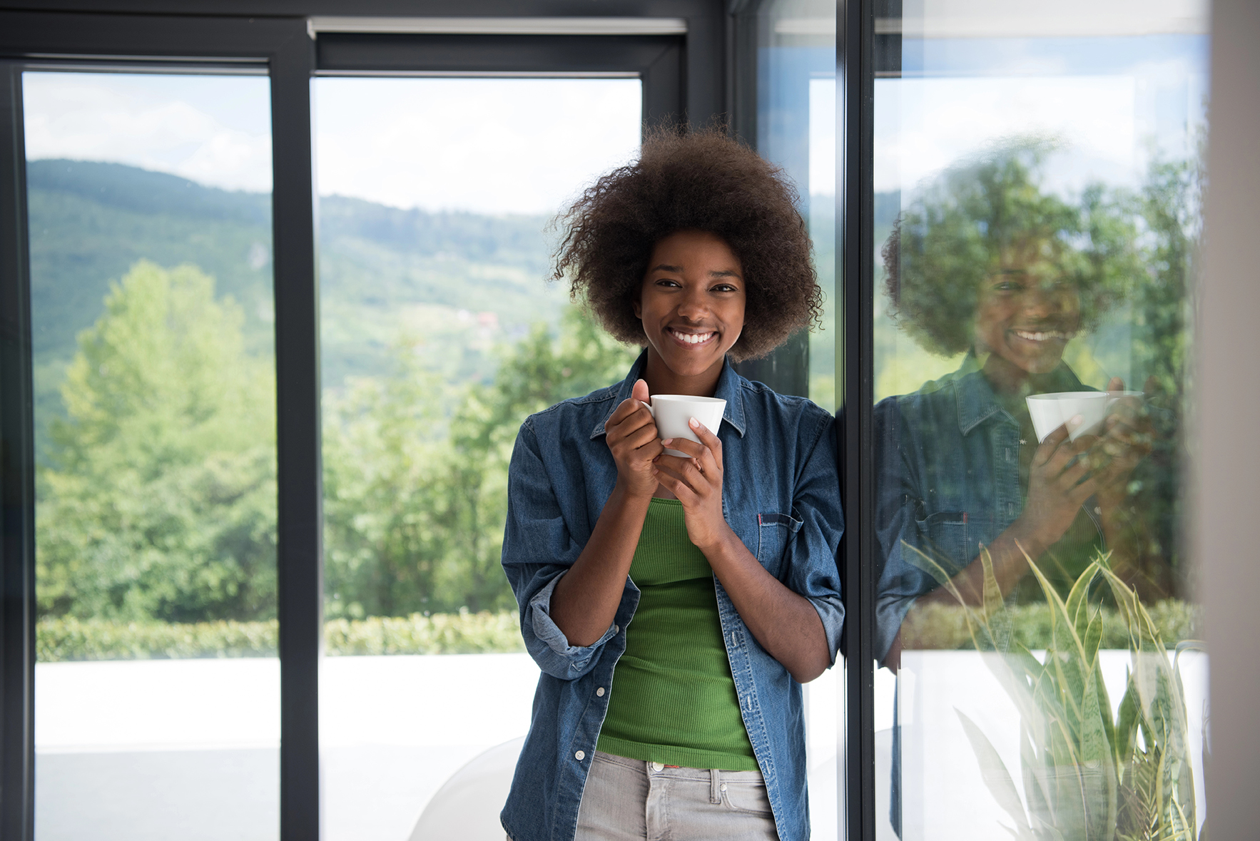 woman drinking coffee and looking through new window in Bergen County, Passaic county, Rockland County