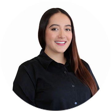 A person wearing a blue checkered sleeve smiling.