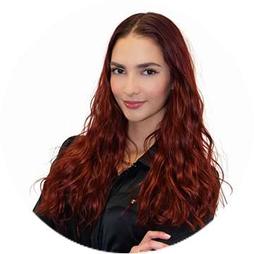 A person wearing a blue checkered sleeve smiling.