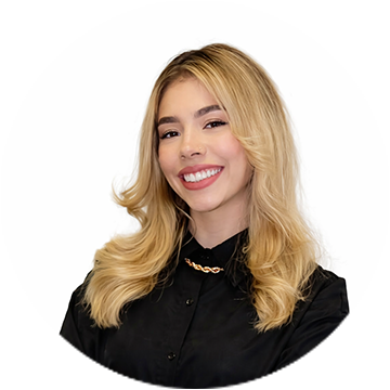 A person wearing a blue checkered sleeve smiling.